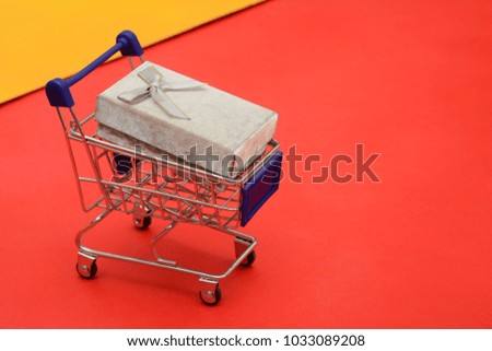 Shopping Cart with gift box on red background banner