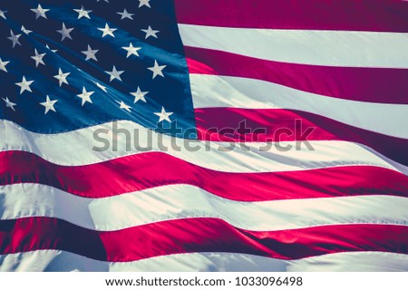 Retro Filtered Image Of A American Stars And Stripes Flag Flying In The Breeze