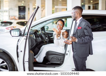 young african woman surprised by new car, gift for my beautiful wife