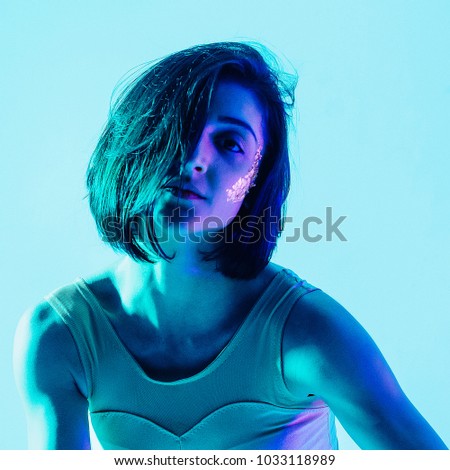 Modern teen contemporary dancer poses in front of the studio background with the hard light. Toned image. Like a doll view. portrait