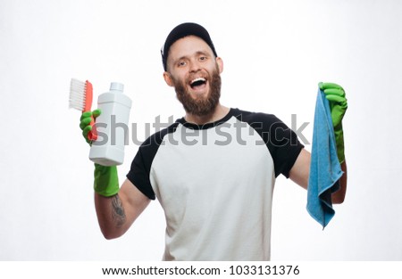 Commercial cleaning. Employee in protective glove with microfiber cloth and cleaning agent. handsome male with beard wearing white blank t-shirt with space for your logo or design