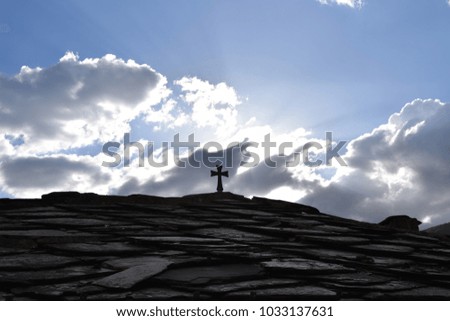 Christian cross on roof temple with sky and cloud background. Macedonia.