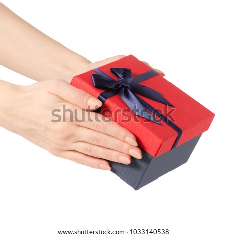 Gift box with a red lid and a blue bow in hand on a white background isolation