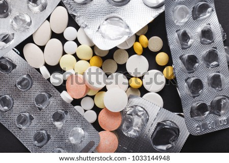 Pills close up on black background. Concept of medical