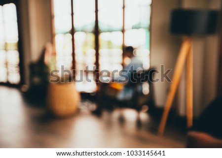 Blurred cafe background with two people sitting near big wimdow.