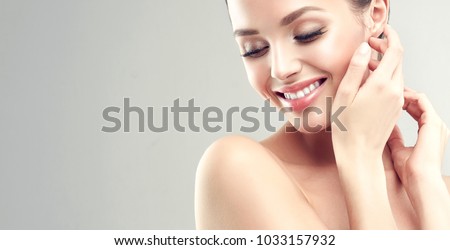 Beautiful young woman with clean fresh skin  .Girl  beauty face care. Facial  treatment   . Royalty-Free Stock Photo #1033157932