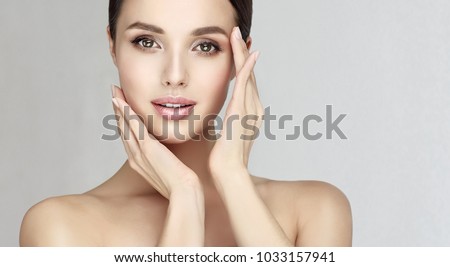Beautiful young woman with clean fresh skin  .Girl  beauty face care. Facial  treatment   . Royalty-Free Stock Photo #1033157941