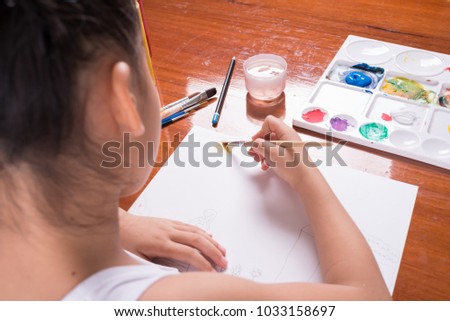 Cute little girl painting a picture