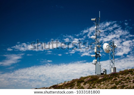 Mountain top weather station with a blue sky and scattered clouds Royalty-Free Stock Photo #1033181800