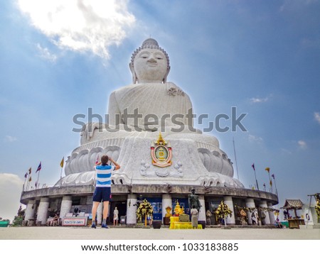 Tourist Taking Photo in front of Giant Buddha Statue in Phuket, Thailand 