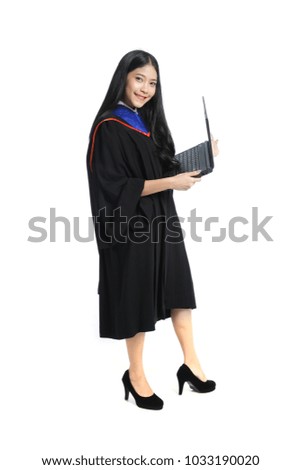 Happy Asian graduate student full body standing and holding laptop or notebook computer isolated on white background