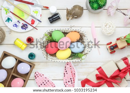 Top view shot of arrangement decoration Happy Easter holiday background concept.Flat lay colorful bunny eggs with accessory ornament on modern beautiful pink paper at office desk.Prepare for season.