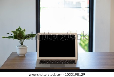 Front view of the laptop is on the work table, interior background, clipping path inside