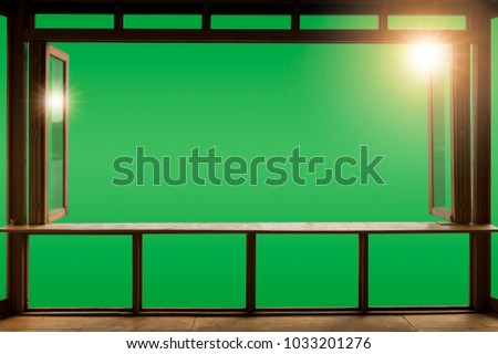 Beautiful cafe style minimal with wood tables and terrace against the outdoor with Green screen blank view isolated in cafe at sunrise and clipping path.