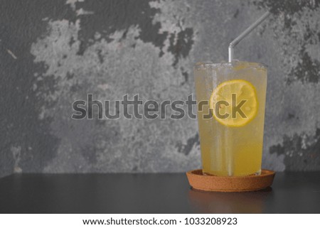Iced lemon soda with rustic gray background