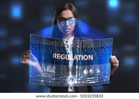 The concept of business, technology, the Internet and the network. A young entrepreneur working on a virtual screen of the future and sees the inscription: Regulation