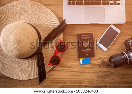 Backgrounds accessories included hat red glasses passport camera Visa card smartphone and laptop place on wooden for travel in beach and sea summer season