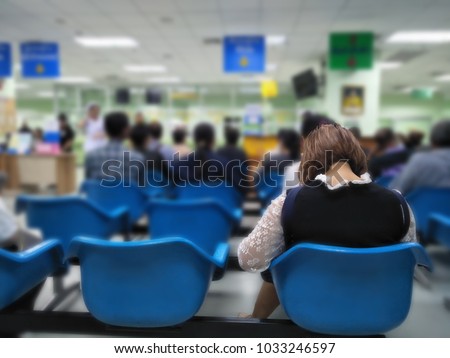 young woman and many people waiting medical and health services to the hospital,patients waiting treatment at the hospital,blurred image of people Royalty-Free Stock Photo #1033246597