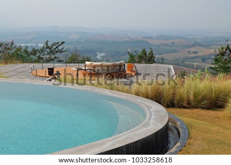 Exterior architecture and building design of Swimming pool and green terrace patio with mountain view and blue sky