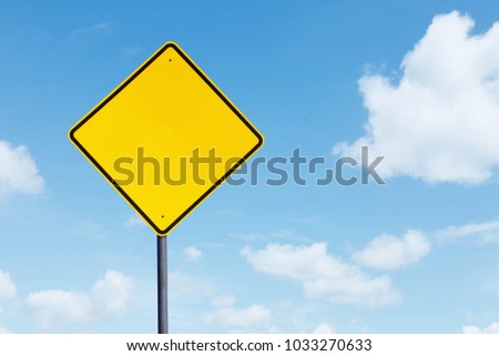 Picture of a blank yellow highway sign under blue sky