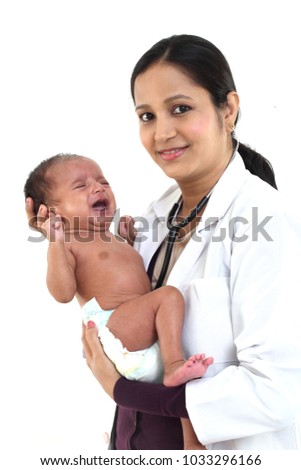 Female doctor holding a newborn baby