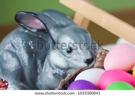 Easter. Easter bunny on a bench with colored eggs