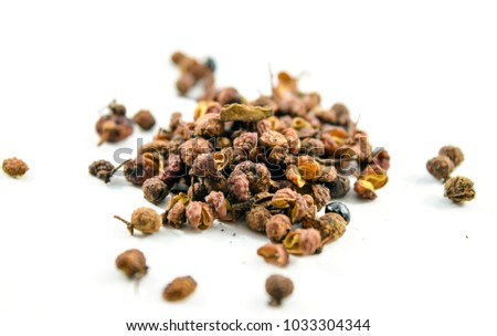 Sichuan or szechuan peppercorns isolated on white background.  They numb the mouth when eaten.