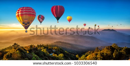 Colorful hot air balloons flying over mountain at Dot Inthanon in Chiang Mai, Thailand. Royalty-Free Stock Photo #1033306540