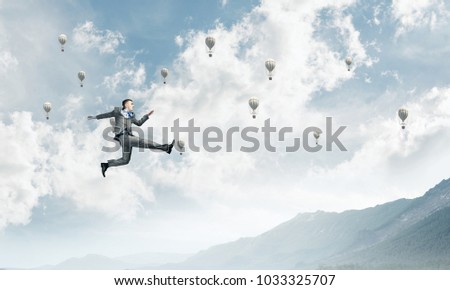 Businessman in suit running in the air as symbol of active life position. Skyscape with flying balloons and nature view on background. 3D rendering.