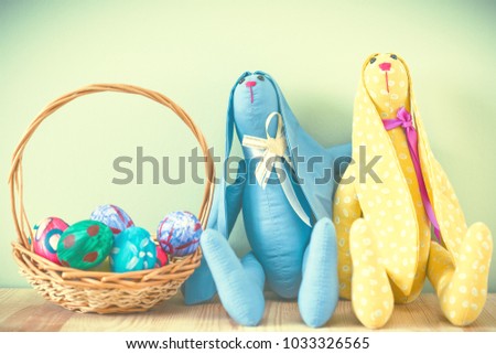 Easter bunny on a green background with Easter eggs. Handmade. Space for text. Rabbit Tilde. Toned image