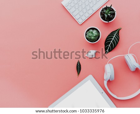 Flat Lay of creative desktop, keyboard, tablet, succulent and headphones. Mock up, flat lay, pastel background 