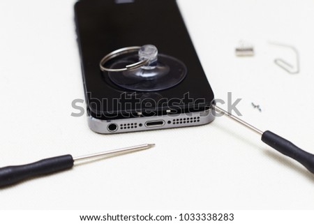 Close-up photos showing process of mobile phone repair, changing the screen.