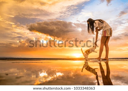 Woman with cat and reflection of sunset