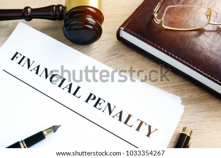 Document with title Financial penalty on a desk. Royalty-Free Stock Photo #1033354267