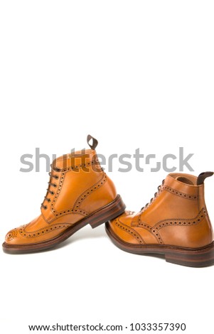 Shoes Concepts. Premium Tanned Brogue Derby Boots of Calf Leather with Rubber Sole. Isolated Over Pure White. Shoes Placed in Line. Vertical Image