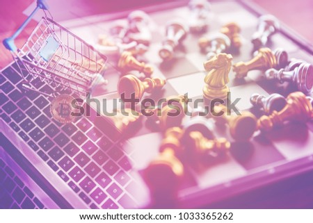 chessman on board game with golden bitcoin in shopping cart on laptop, business and finance concept