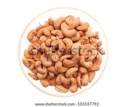 Cashew nuts in a glass bowl. Isolated on white.