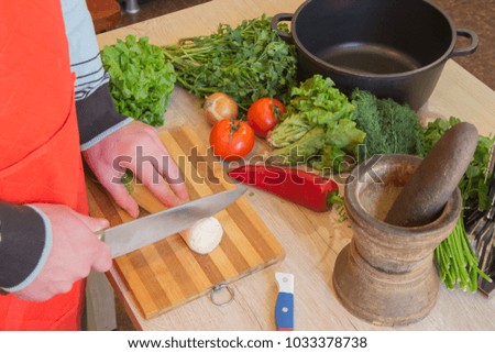 Young Male Cooking in the kitchen. Healthy Food. Cropped image of young Man cutting vegetables for Food. Preparing dishes
