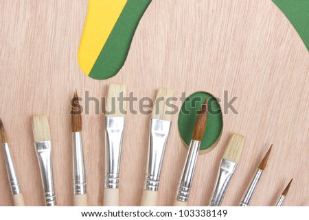 Wooden art palette with a brush on white background