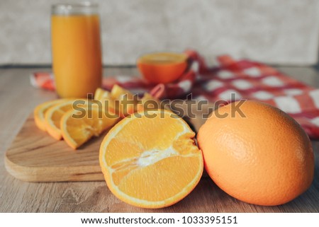 oranges on a cutting board and juice