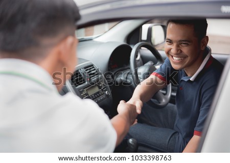 driver and friend or customer shake hand Royalty-Free Stock Photo #1033398763