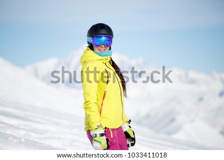 Portrait of sports girl in helmet on mountainside