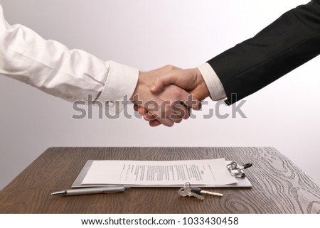 Handshake after signing a purchase contract