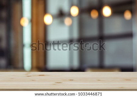 Empty wooden table top with view of room or wooden desk with restaurants with blur background, copy space for your text