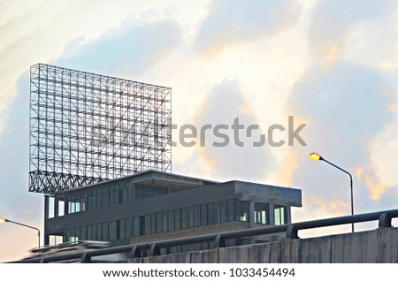 bill board frame or rack on top of building beside road and toll way ,bottom up view