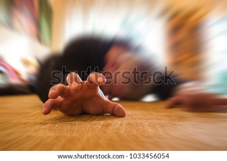 a man lies unconscious in his apartment Royalty-Free Stock Photo #1033456054