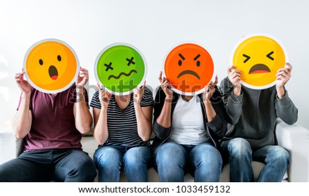 Diverse people holding emoticon Royalty-Free Stock Photo #1033459132
