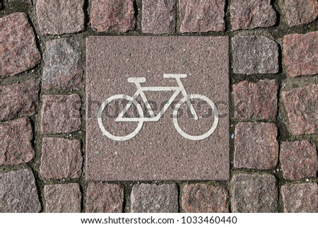 Sign "bicycle path" on the sidewalk cobblestones