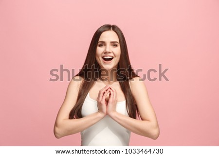 Happy business woman standing and smiling isolated on pink studio background. Beautiful female half-length portrait. Young emotional woman. The human emotions, facial expression concept. Front view.
