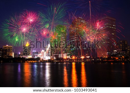 The colorful fireworks on city, urban and lake in the night as beautiful background concept